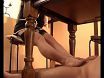 He lies under table and gets a stockings footjob